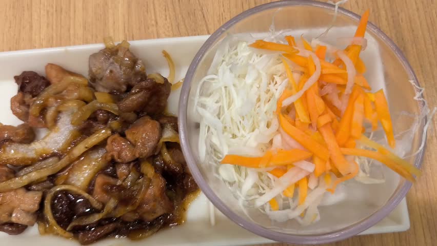 Delicious Japanese platter featuring fried shrimp, dumplings, teriyaki chicken, fresh salad colorful