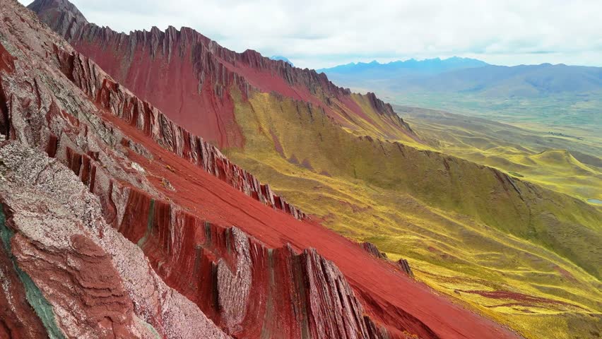 Aerial drone view of Pallay Punchu with multicolored ridges. At 4,791 meters, people enjoy the summit view. Cusco, Peru	
