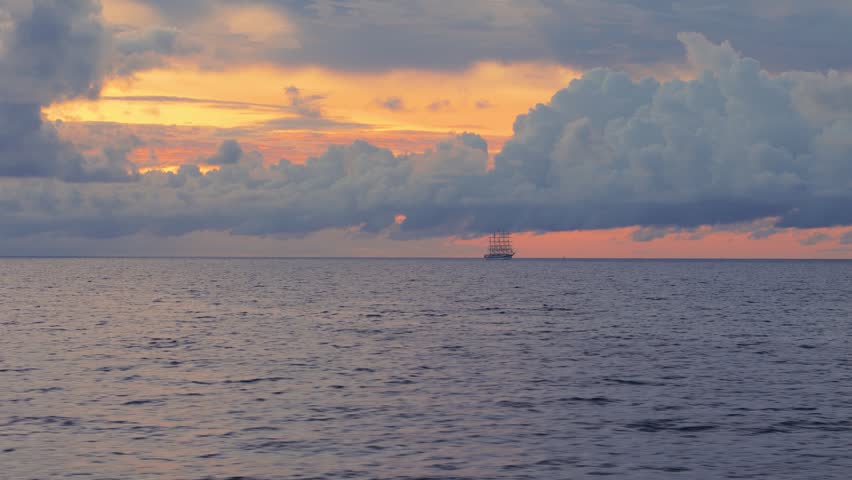 Drone aerial view of sailing ship silhouette on sunrise horizon in Caribbean near Curacao coast