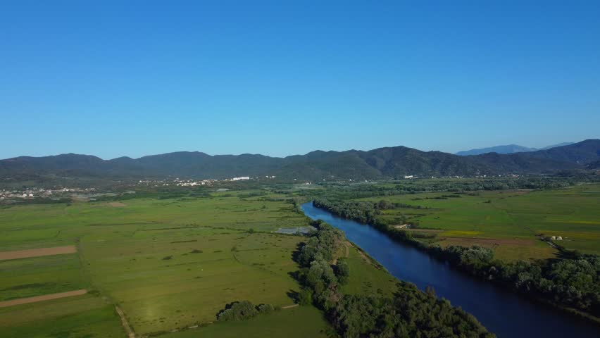 Green spring forest, spring lake and green grass in the meadow, beautiful sunlight on the mountain in the middle of forest, blue sky and clouds, Spring in Africa Algeria Jijel National Park. Summer.