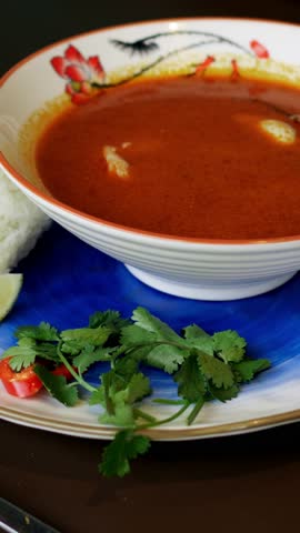 Flavorful seafood dish featuring shrimp immersed in spicy herbal broth served in clean bowl. Enjoy tender shrimp steeped in fragrant herbal spicy broth served beautifully in pristine bowl