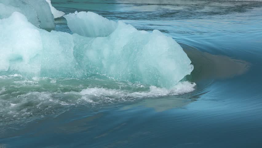 Glaciers  are melting as global warming changes the climate. Icebergs drift in the water while the landscape shows signs of warming effects. Observe these changes.