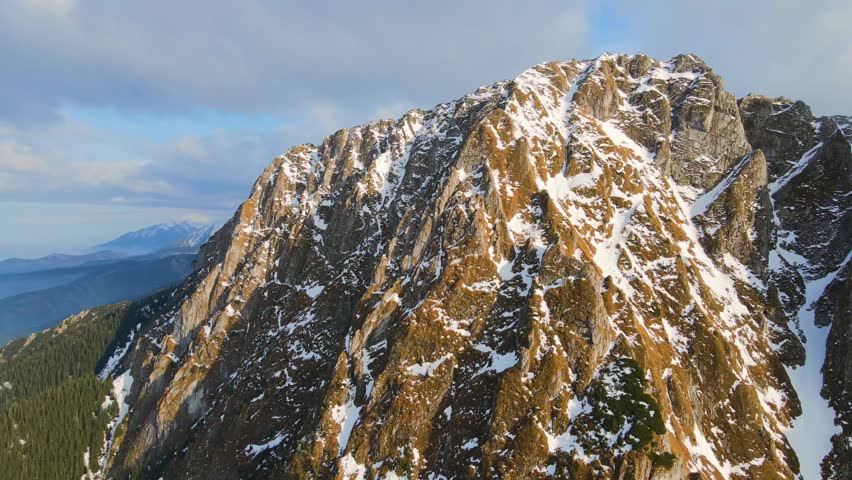 Mountain landscape and vast valleys. Cloudscape over snow-capped cliffs. Alaska, USA.