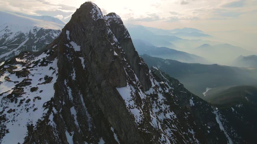 Mountain landscape and vast valleys. Cloudscape over snow-capped cliffs. Alaska, USA.