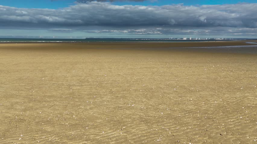Aerial drone view of a sandy beach on the English Channel coast of Normandy, France. High quality 4k footage