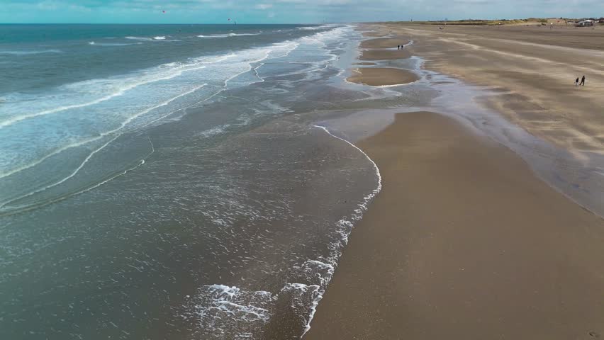 Aerial drone view of a sandy beach on the English Channel coast of Normandy, France. High quality 4k footage