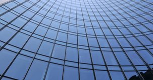 Low angle view of curved glass skyscraper facade with modern architecture lines against clear sky. - Powered by Shutterstock - Get 15% off with code: PIKWIZARD15