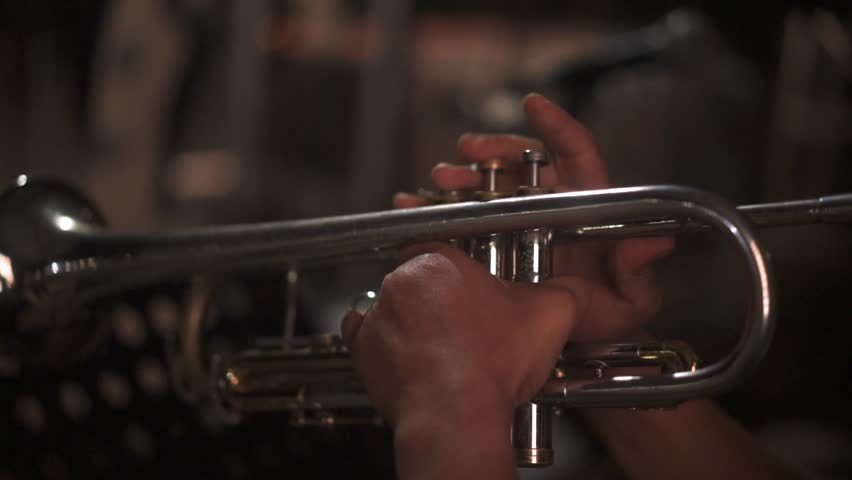 Professional Musician Playing Silver Trumpet in Live Jazz Performance