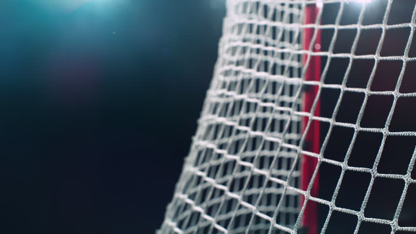 Super Slow Motion Hockey Goal on Black Background. Puck Hitting Net at 1000fps