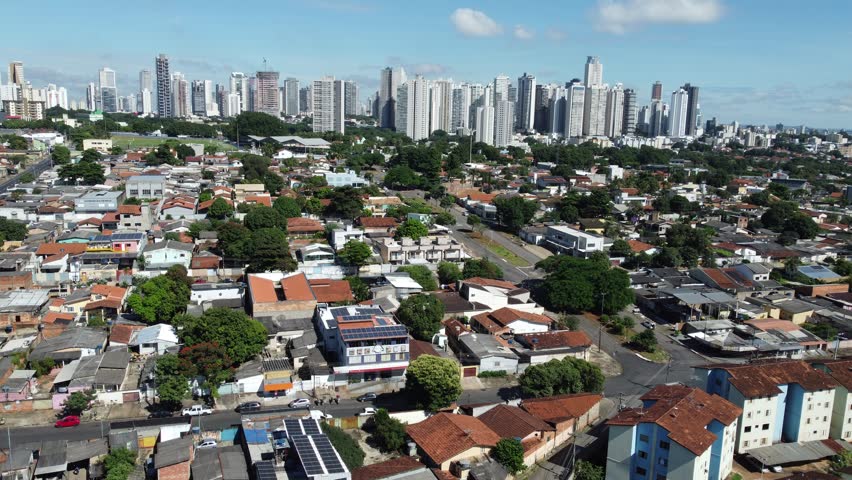 Aerial tracking drone shot moving towards the modern skyline of Setor Bueno and Marista districts with high-rise buildings in Goiania, Brazil.