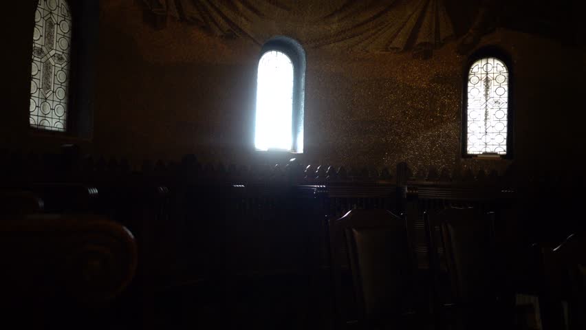 Cluj-Napoca, Romania A man walks in a small sunlit chapel in the Dormition of the Mother of God Metropolitan Cathedral.