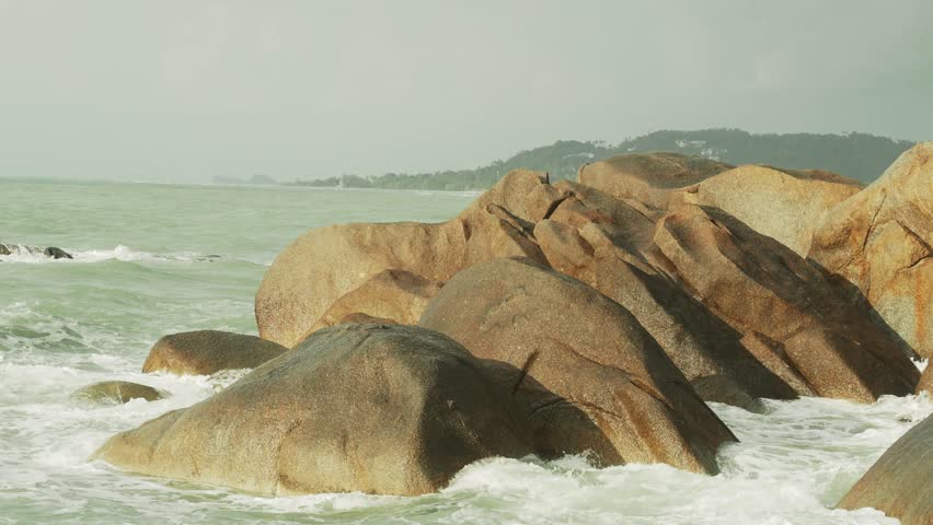 Splashing sea waves over big rocks  