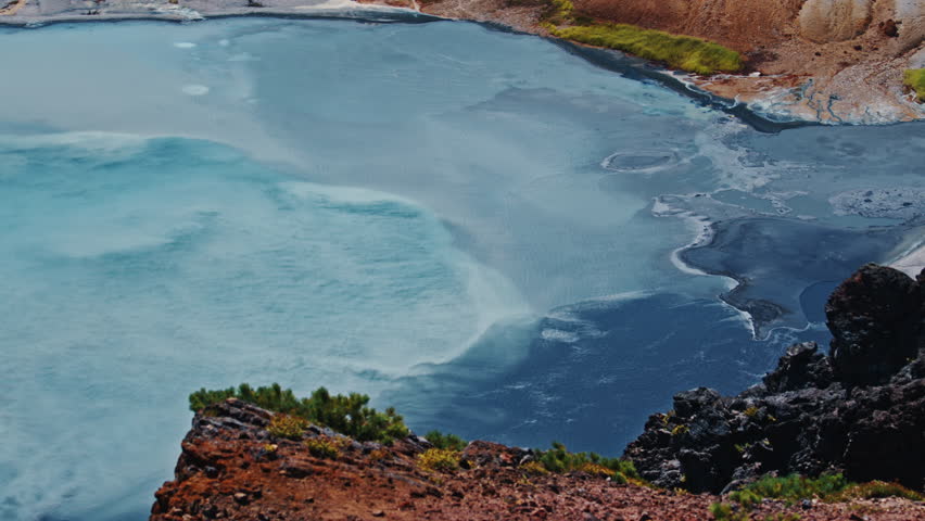 Lake with milky blue boiling water in the active volcanic area of volcano of Golovnin on Kunashir island in Russia