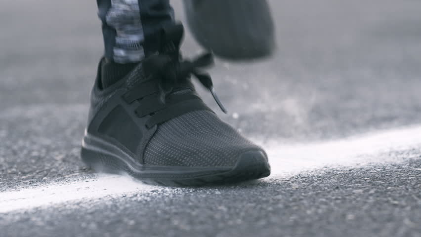 Fitness, chalk and feet of person outdoor with warm up for running, workout or challenge for health. Sports, gym powder and shoes of athlete preparing for cardio exercise in road for wellness.