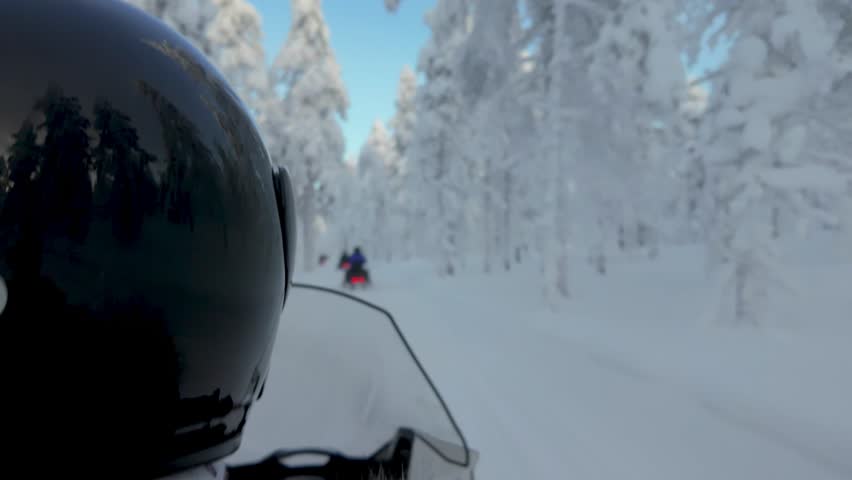 Embark on a thrilling snowmobiling journey through the stunning, snow-covered forests of Akaslompolo, Lapland. Experience the serene beauty of winter in Finland.