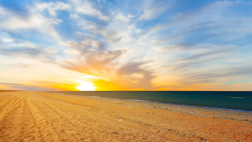 dramatic sunset over sandy sea beach time lapse scene