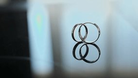 Wedding gold rings captured from an unusual angle, slow motion. Contemporary style - Powered by Shutterstock - Get 15% off with code: PIKWIZARD15