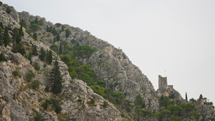 Ancient Mirabella fortress on steep mountain cliffs.
