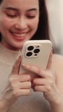 Happy Asian woman writes message on smartphone in city vertical shot. Smiling Chinese female texts to boyfriend in virtual chat by modern mobile phone on sunset street. Focus on a gadget - Powered by Shutterstock - Get 15% off with code: PIKWIZARD15