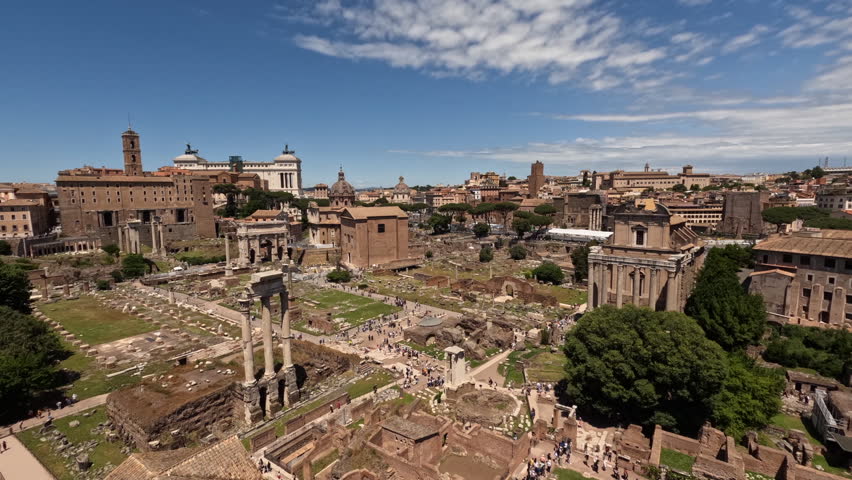 Stunning time lapse of Roman Forum ancient ruins under blue sky with clouds. Iconic columns, temples and archaeological site showcase Rome