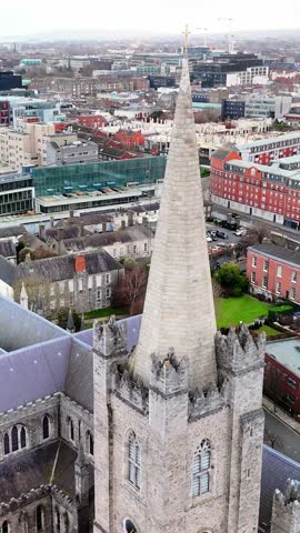 Vertical aerial drone view of St. Patrick’s Cathedral in Dublin, Ireland. View of the historic building.	