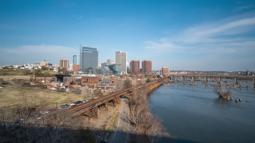 Richmond, Virginia skyline and James River from a high overlook, featuring moving clouds and the urban landscape. Elevated wide-angle 4k long exposure timelapse.