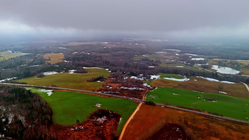 Panoramic aerial of farmland showing seasonal changes and snow