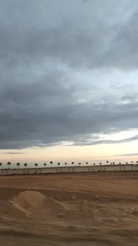 On the road at winter sunset, driving through various places under a sky full of clouds.