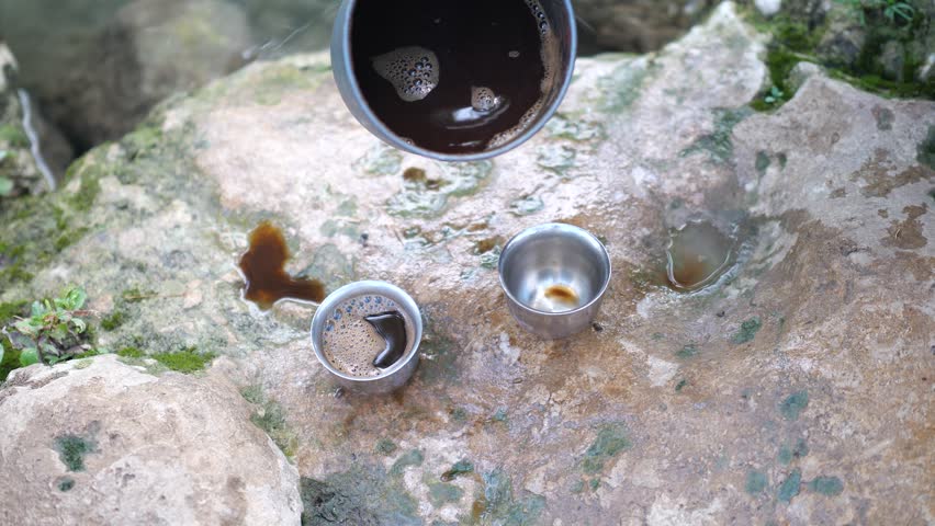 Camping Coffee Pouring Into Metal Cups On Rock