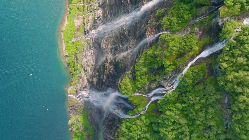 Seven Sisters Waterfall, Geiranger Fjord, Norway. Nature in fjords. Traveling through the Norwegian fjords. Scandinavia. View of nature from the drone. Vacation and travel in summer Norway.