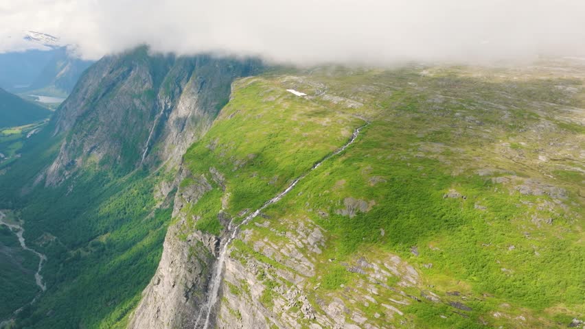 Aerial drone shot of the scenic fjord in Norway. Scandinavian nature. High mountains and deep fjords in the north. Concept of travel, vacation and arctic nature.