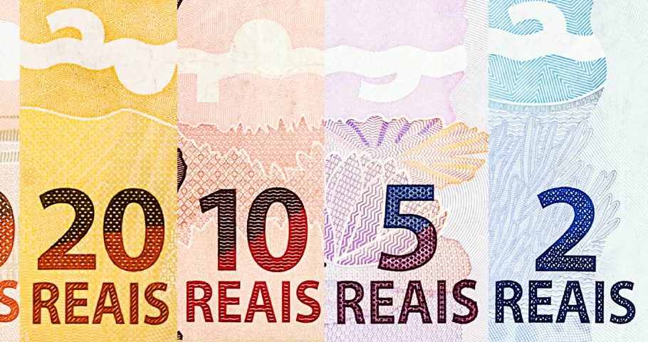 details of banknotes of 100 reais from brazil, and brazilian coins, with selective focus, background image. Promotion concept or grand prize money.