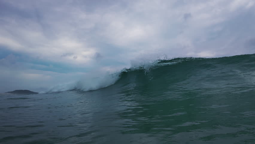 Ocean wave breaks on the shore. Wave rolls and breaks over the coastal area. Underwater camera