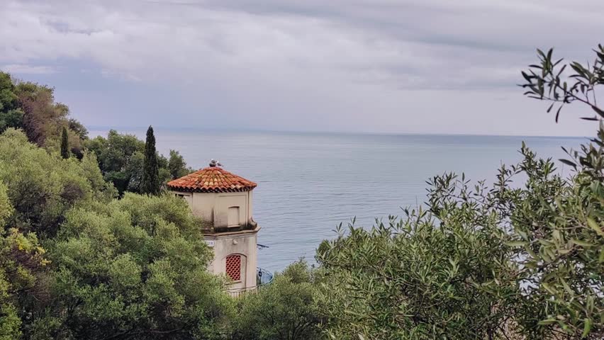 France, Nice, sea view from the Castle Hill waterfall, with an old yellow watchtower in the frame
