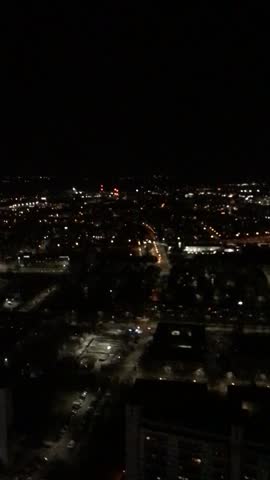 2026 experimental recording of a main street in Wroclaw, Poland, at night from a publicly accessible platform. Starts with a dynamic movement from the sky and stops at the crossroads as the static focal point from a vertical perspective. The calm traffic shown by one moving tram and a couple of cars contribute to a peaceful atmosphere.
