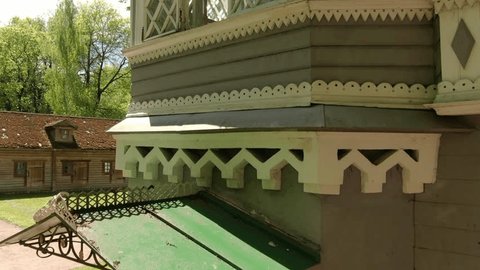 Drone Ascending beside Historic House Facade