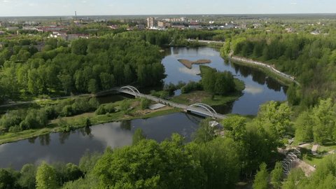 Drone Descending Forward over River Park