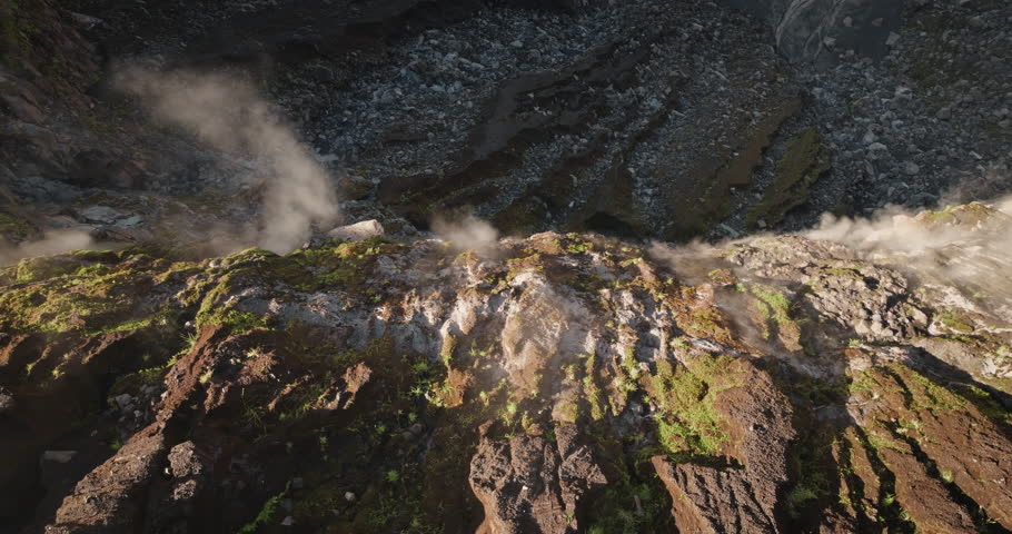Ambrym Island volcano crater surface vent fuming steam and gas smoke from panoramic drone flight view, dramatic active volcanic landscape in Vanuatu showcasing raw geothermal power and rugged terrain
