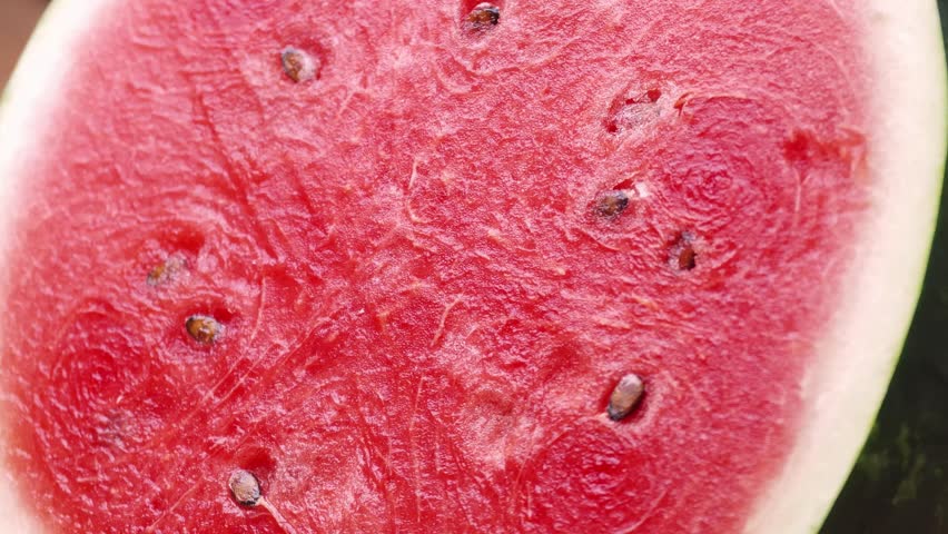 Half of watermelon on a wooden board.