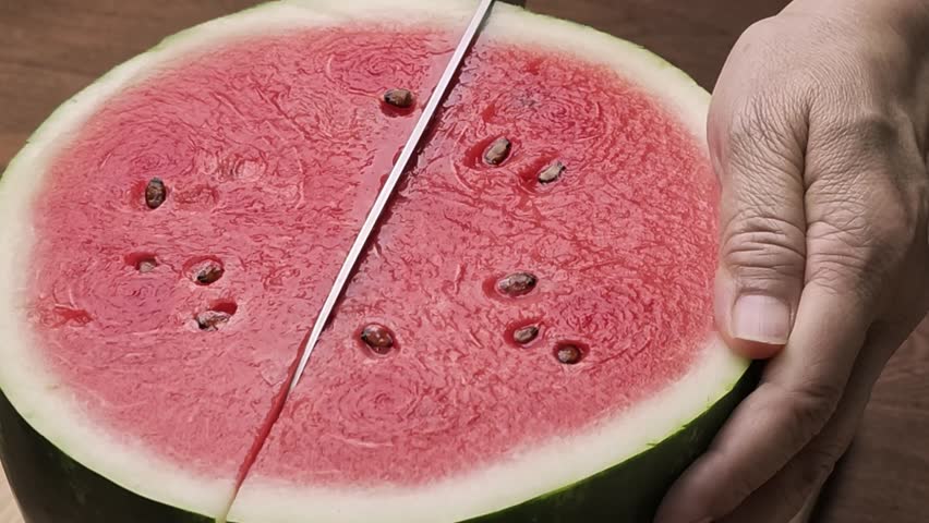 Slices of watermelon on a wooden board.