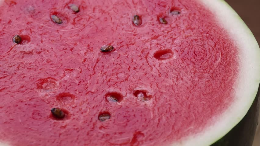 Half of watermelon on a wooden board.