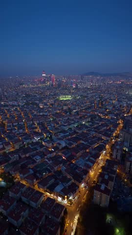 Aerial view of city of Istanbul at night featuring glowing street lights and dense urban architecture in Turkey