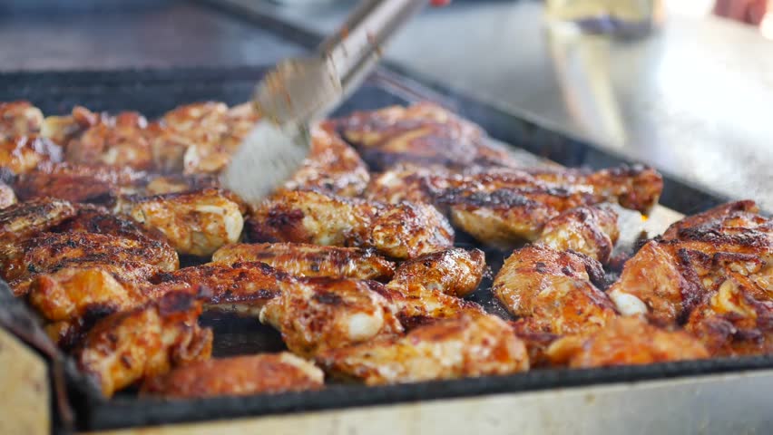 Chicken wings cooking on a grill