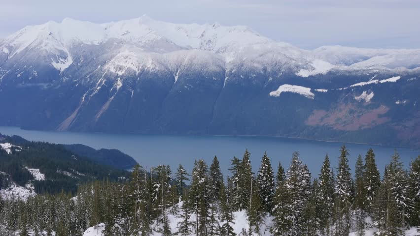 Stunning Winter Landscape of Snow-Capped Mountains, Lake, and Forest in British Columbia, Canada