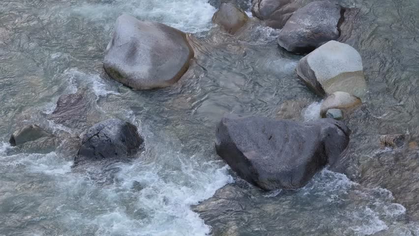 Rushing River Water Flows Over Smooth Rocks in Scenic British Columbia, Canada