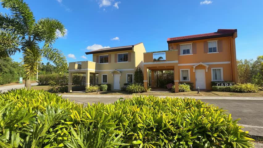 Ground level horizontal view showing a clean, well-developed village side with finished houses and a small mini park at Camella Homes Alfonso Cavite Philippines
