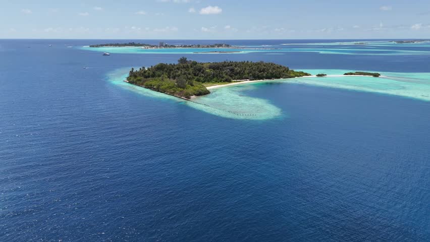 Remote Maldives Island Surrounded by Deep Blue Ocean Aerial