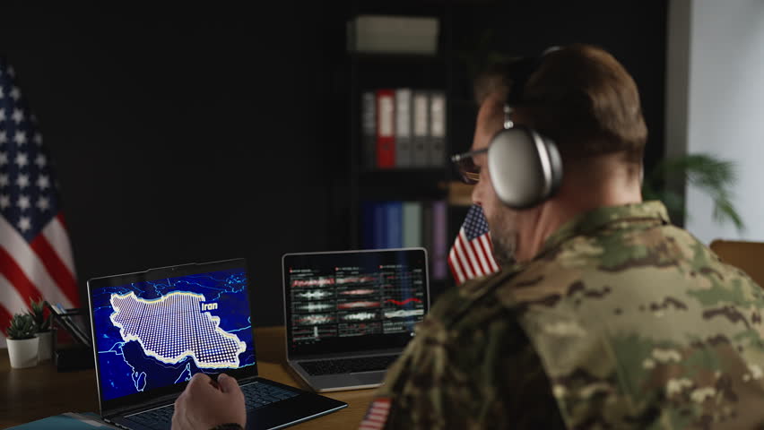 U.S. army officer in headset coordinating Iran secret operation in real time