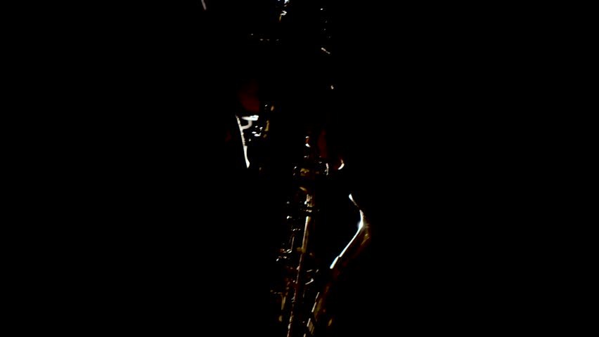 Close up video of musician man playing saxophone. Low light and selective focus. Saxophone player closeup video