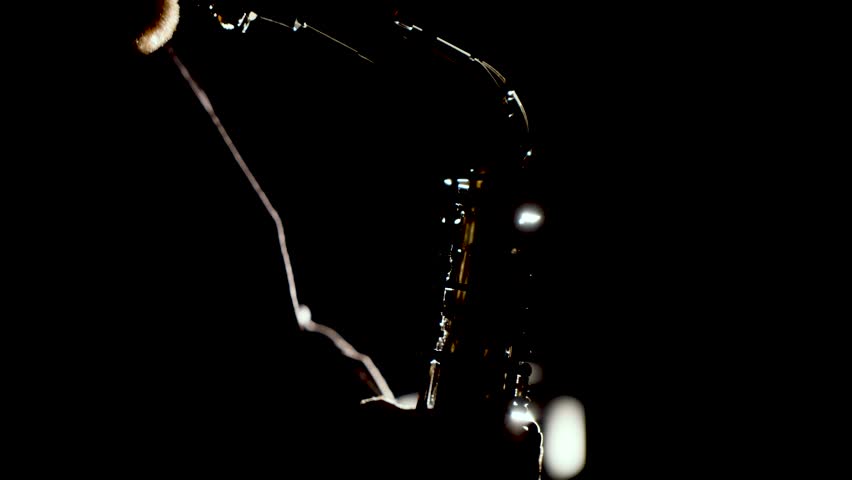Close up video of musician man playing saxophone. Low light and selective focus. Saxophone player closeup video